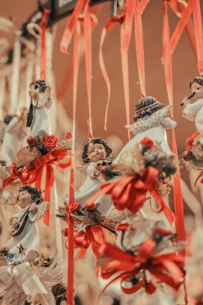 Charming handmade angel figurines adorned with red ribbons, perfect for festive celebrations.